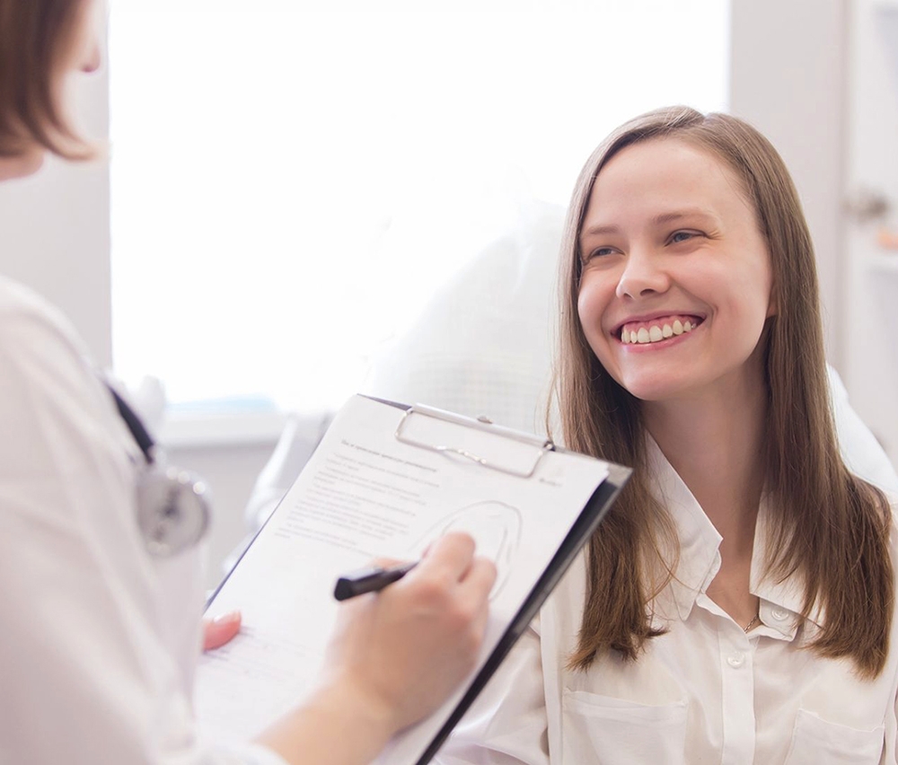 girl smiling with patient form